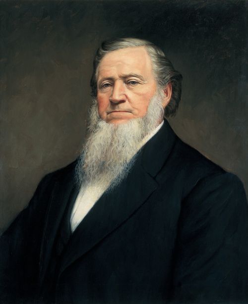 A painted portrait by John Willard Clawson of Brigham Young with a long white beard, wearing a black suit.