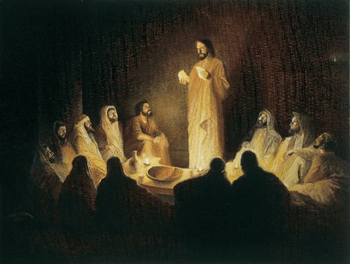 Jesus Christ depicted with the Apostles at the Last Supper. The Apostles are gathered around a table. Christ is standing before them and breaking bread as He institutes the sacrament.