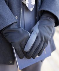 A missionary models appropriate jackets and suits as he puts on gloves.