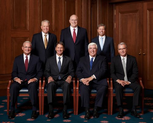 The Presidency of the Quorum of the Seventy take a photo in 2021. The image includes - Standing: Brent H. Nileson, Paul V. Johnson, S. Mark Palmer, Sitting: Patrick Kearon, Carl B. Cook, Jose A. Teixeira, Carlos A. Godoy