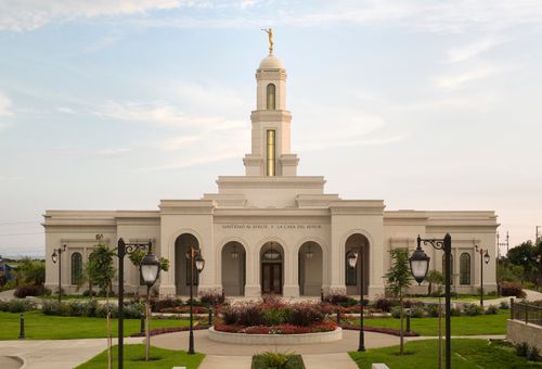 A view of the Trujillo Peru Temple, with a row of black street lamps lining the path leading to the entrance.
