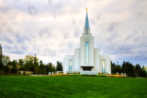 The grounds in front of the Vancouver British Columbia Temple, surrounded by trees.