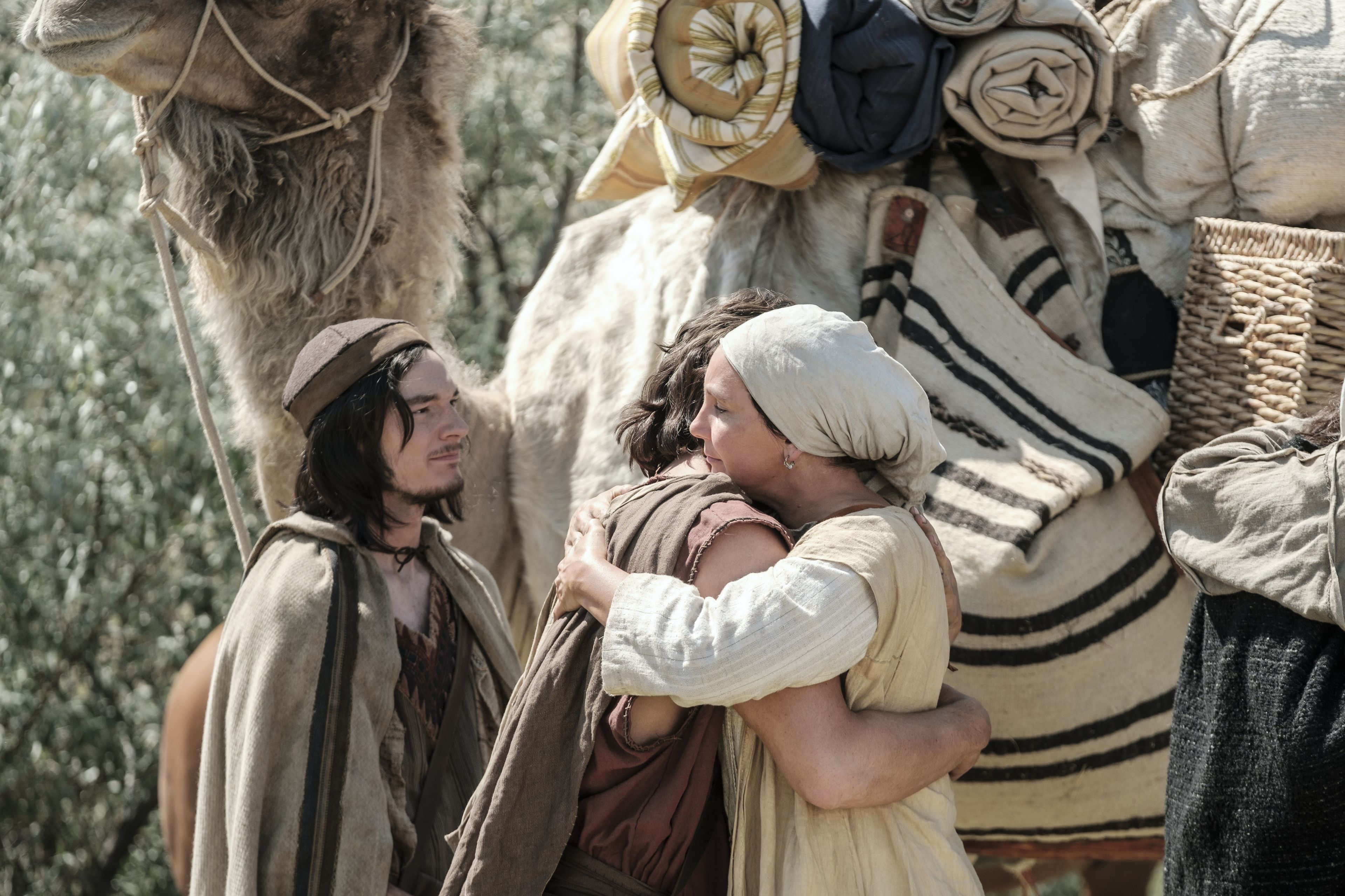 Sariah hugs Nephi upon his return from Jerusalem.