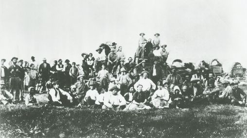 A large group photo of Mormon Pioneers on the Great Plains of the United States.