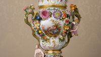 1930 Meissen vase donated by the Swiss Austrian Mission to the Relief Society Building Fund in 1947. The vase is decorated with intricate flower designs.