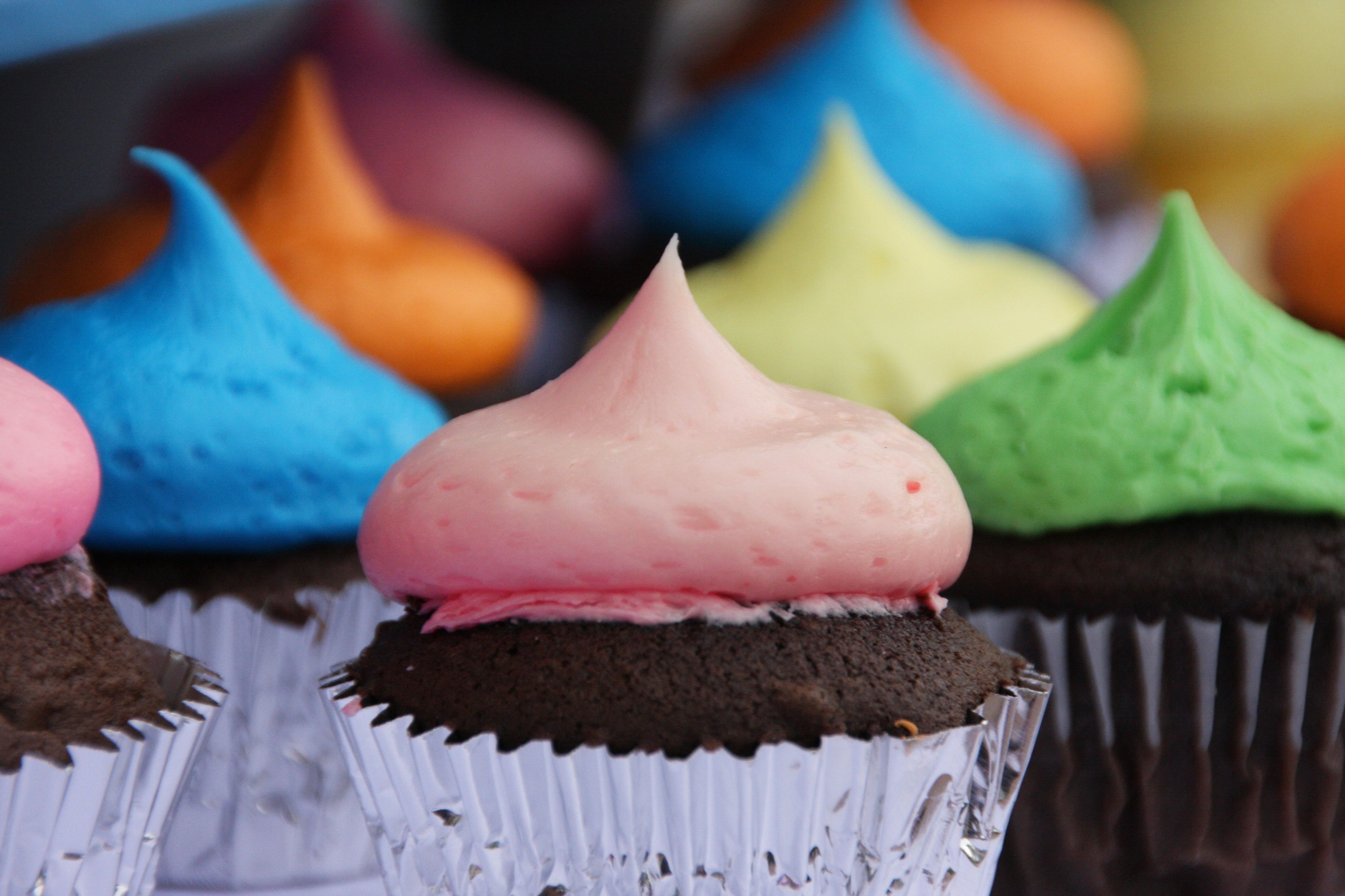Chocolate cupcakes with colored frosting.