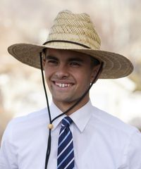 Various missionaries model appropriate dress and attire as they look to camera wearing a hat.