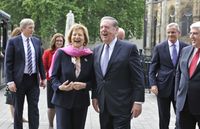 Elder Jeffrey R. Holland walking with Baroness Emma Nicholson in London, England in June 2015.   They are in an outdoor setting.   Elder Holland was a guest of the Baroness to address the British Parliament.  Elders Jose A. Teixeira, Patrick Kearon and Clifford T. Herbertson are walking with Elder Holland and the Baroness.
