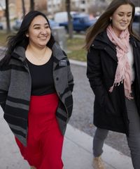 Various sister missionaries model appropriate dress and attire as they walk together. They are wearing approved dresses, blouses, and pants.