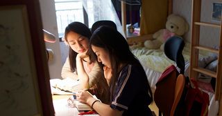 young women studying the scriptures together