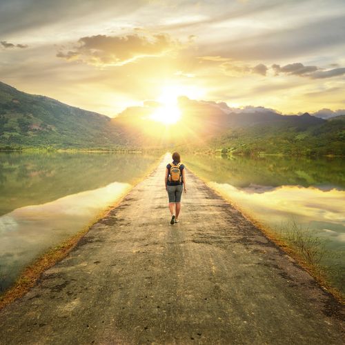 young woman walking down road
