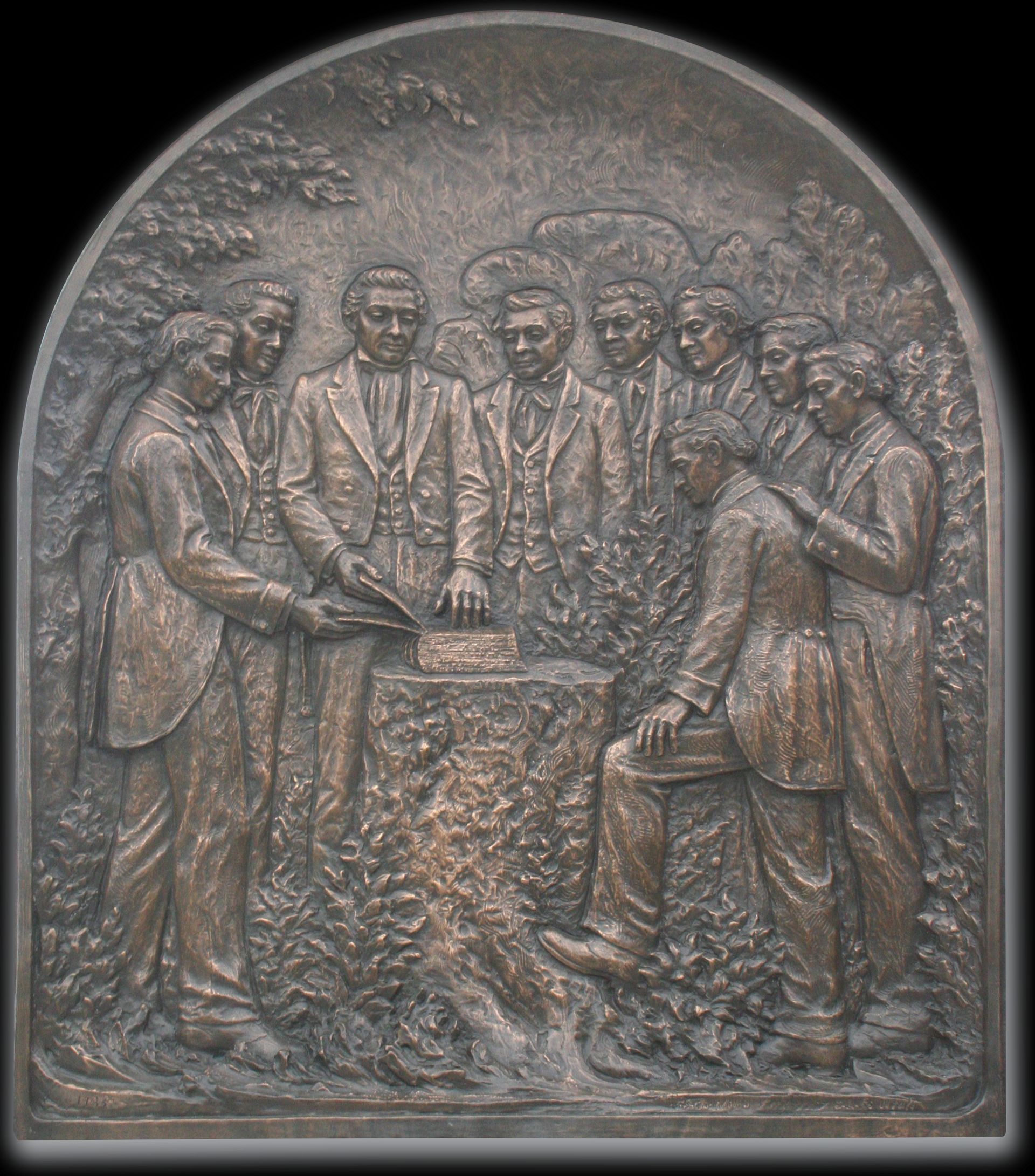 Plaque of Joseph Smith showing plates.