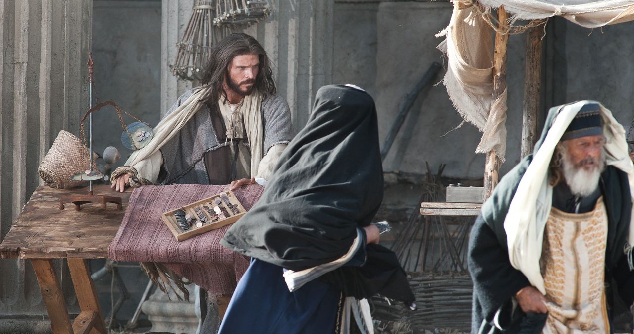 Jesus cleanses the temple, overturning the tables of the moneychangers