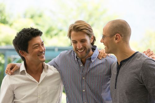 three men smiling
