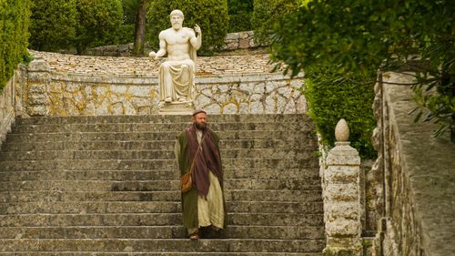 Paul walking down steps in Athens