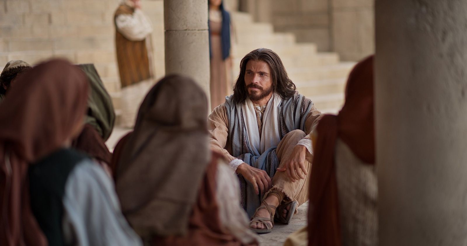 Christ is sitting down on the ground in the temple teaching a group of people.  Outtakes included some more of Jesus teaching, the other outtakes with this image are from a different title: "Jesus Christ. Light of the World" showing Christ after the event of the Woman taken in Adultery and the Jews questioning his authority.