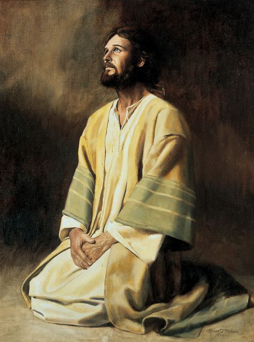 Christ in white, yellow, and green robes, kneeling with hands folded, looking upward, against a plain background.