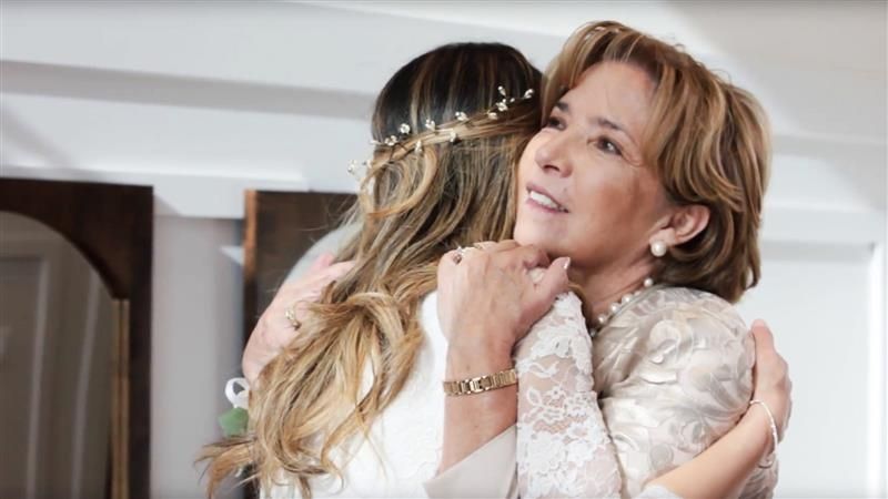 A woman hugs her daughter