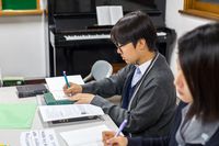 youth writing in classroom