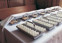 Prepared sacrament bread and water trays sitting on the sacrament table.