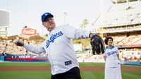 Elder Jeffrey R. Holland throws out the ceremonial first pitch as his wife, Patricia, looks on at Dodger Stadium in Los Angeles, California, on June 28, 2013.