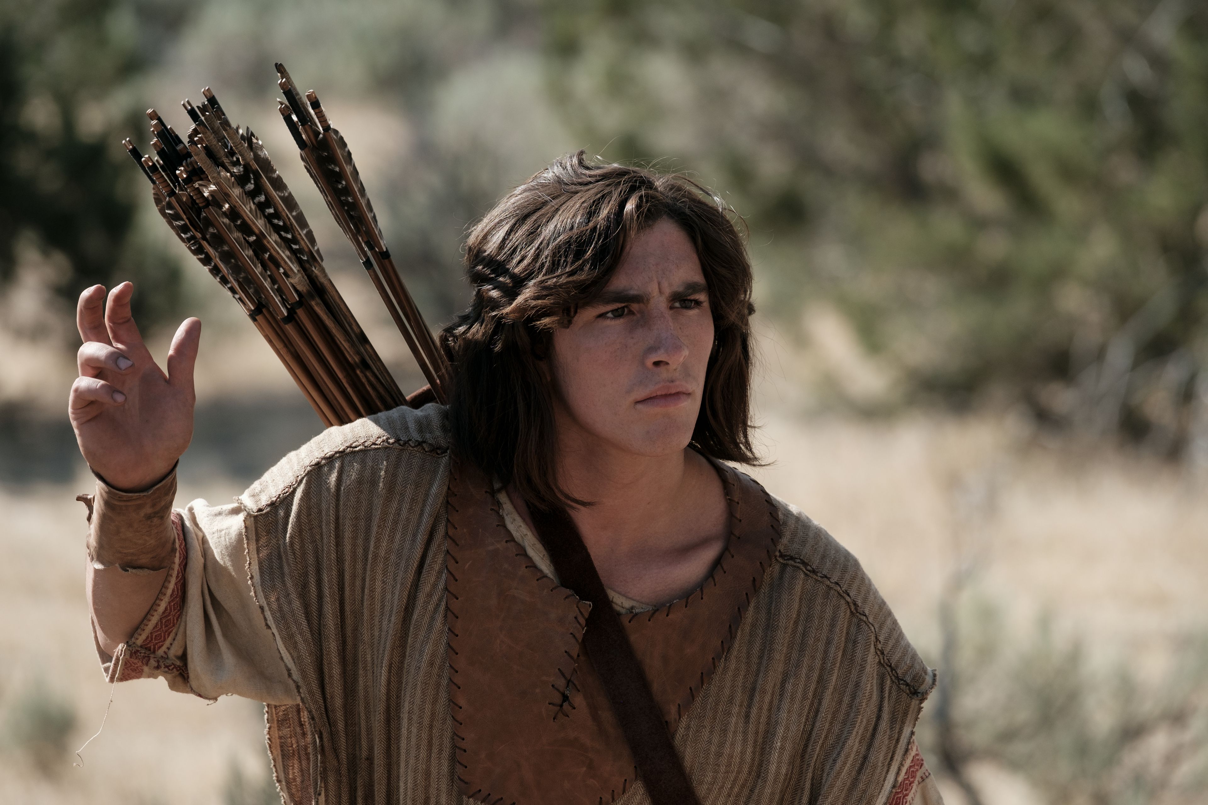 Nephi reaches for an arrow as he hunts in the wilderness.