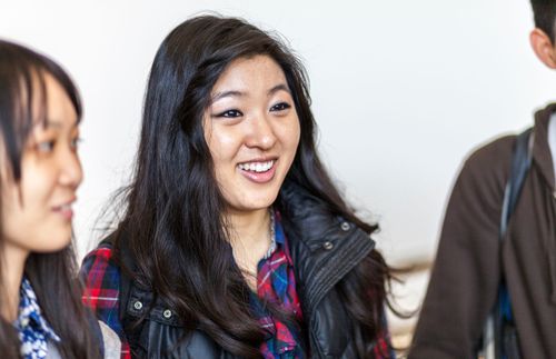 A woman smiles in a group of friends