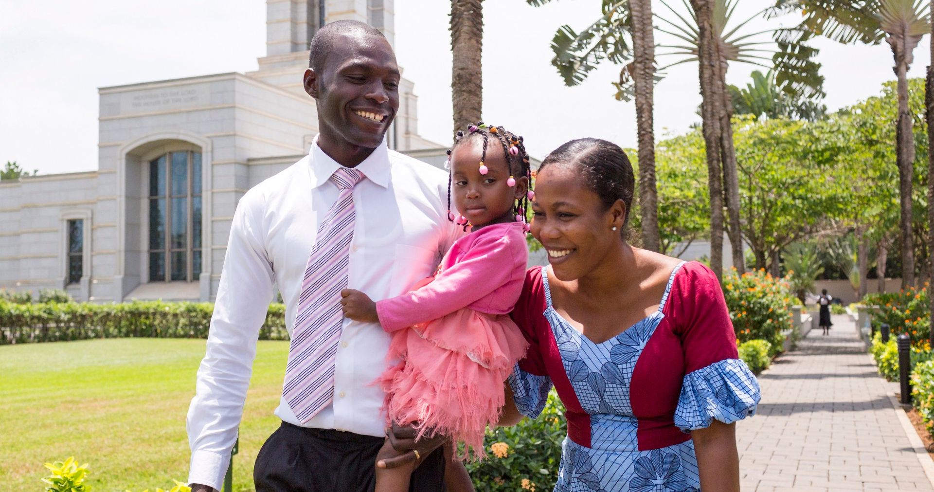 A Ghanaian family walks the grounds of the Accra Ghana Temple together.