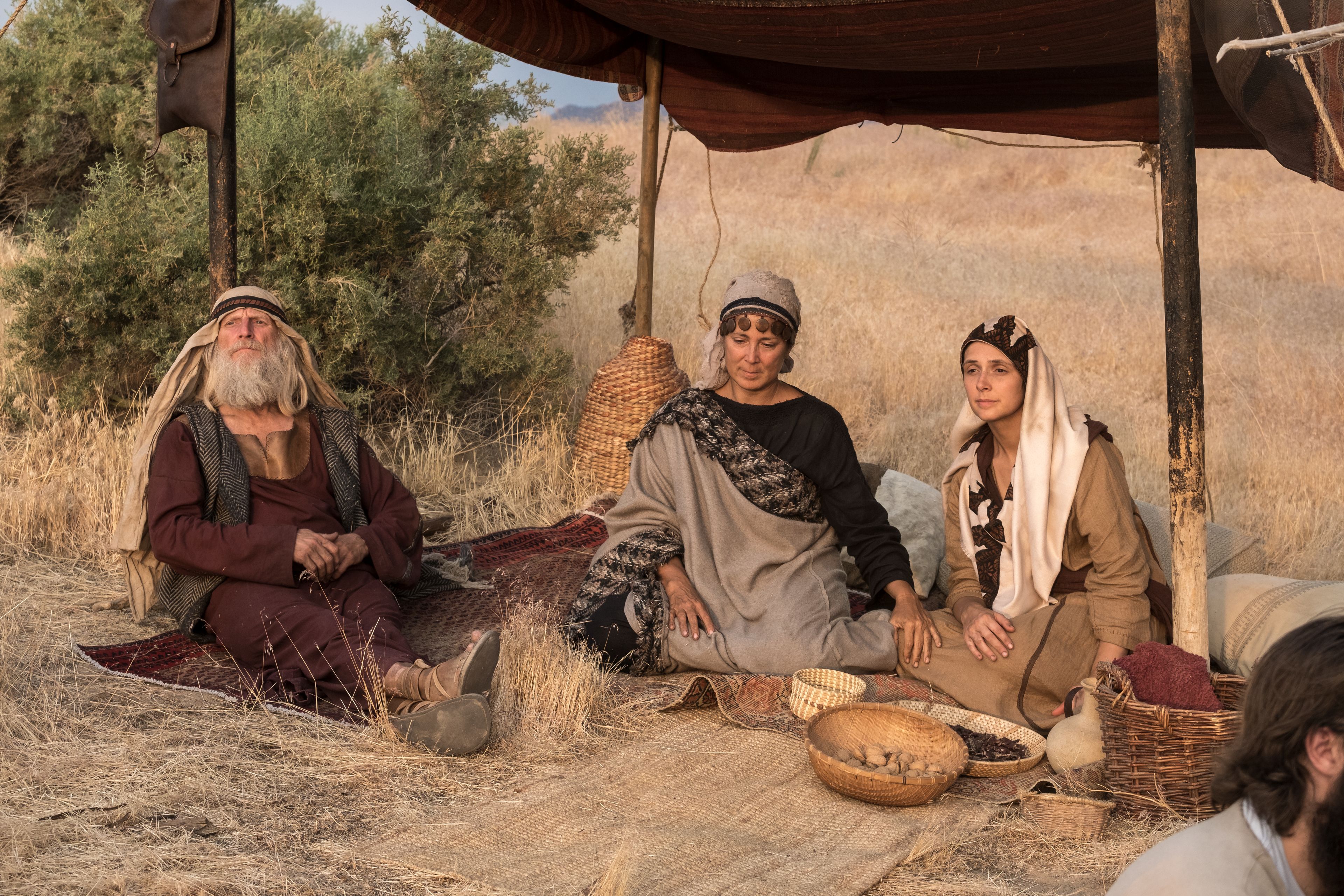 Ishmael, his wife, and his daughter sit in a tent in the wilderness.
