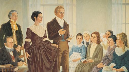 A painting by Nadine Barton of Joseph Smith Jr. and his wife Emma Smith standing before a group of sitting women as they organize the Relief Society.