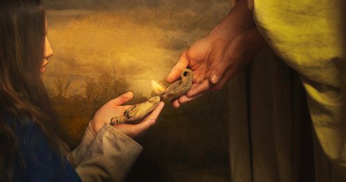 Photographic illustration of the hands of Jesus Christ holding an oil light to light another lamp held by a woman who kneels before him.