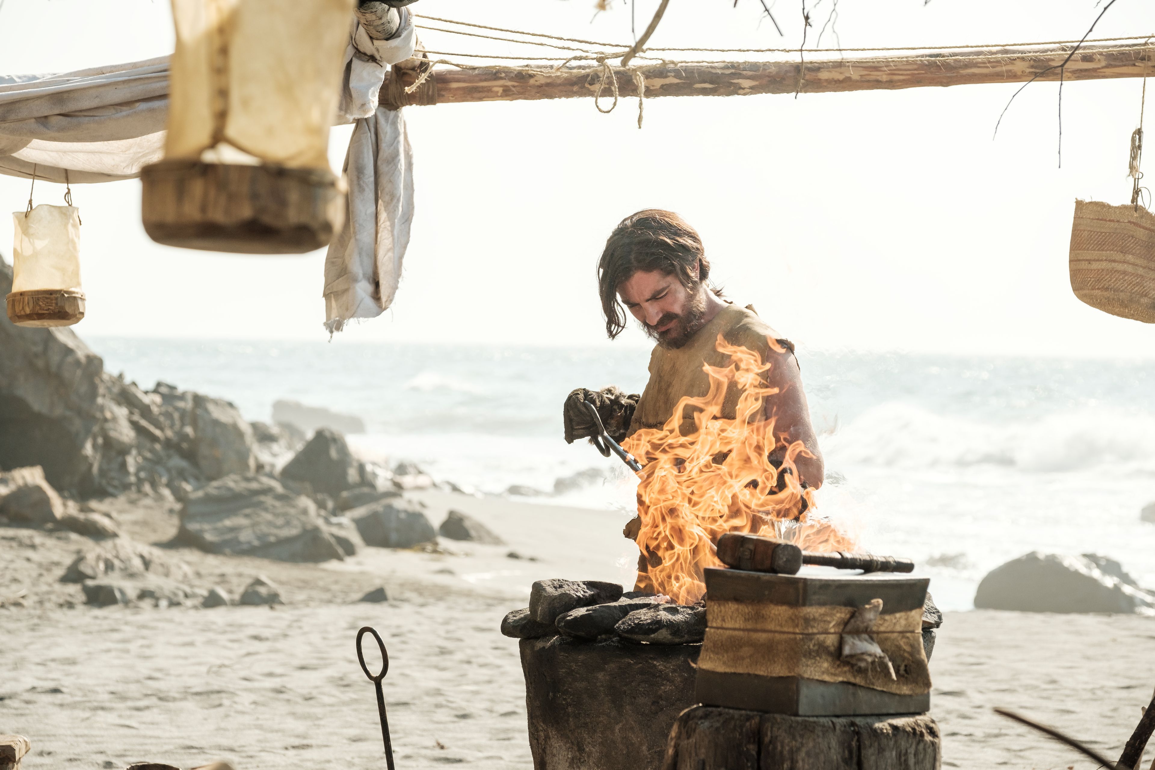 Nephi works the forge on the seashore.