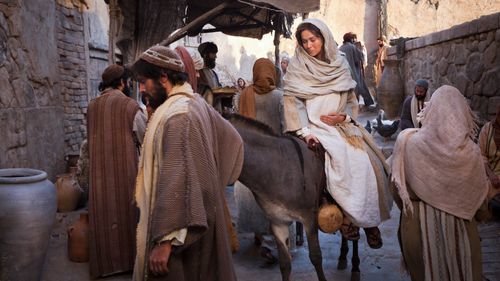 Joseph leading pregnant Mary on a donkey