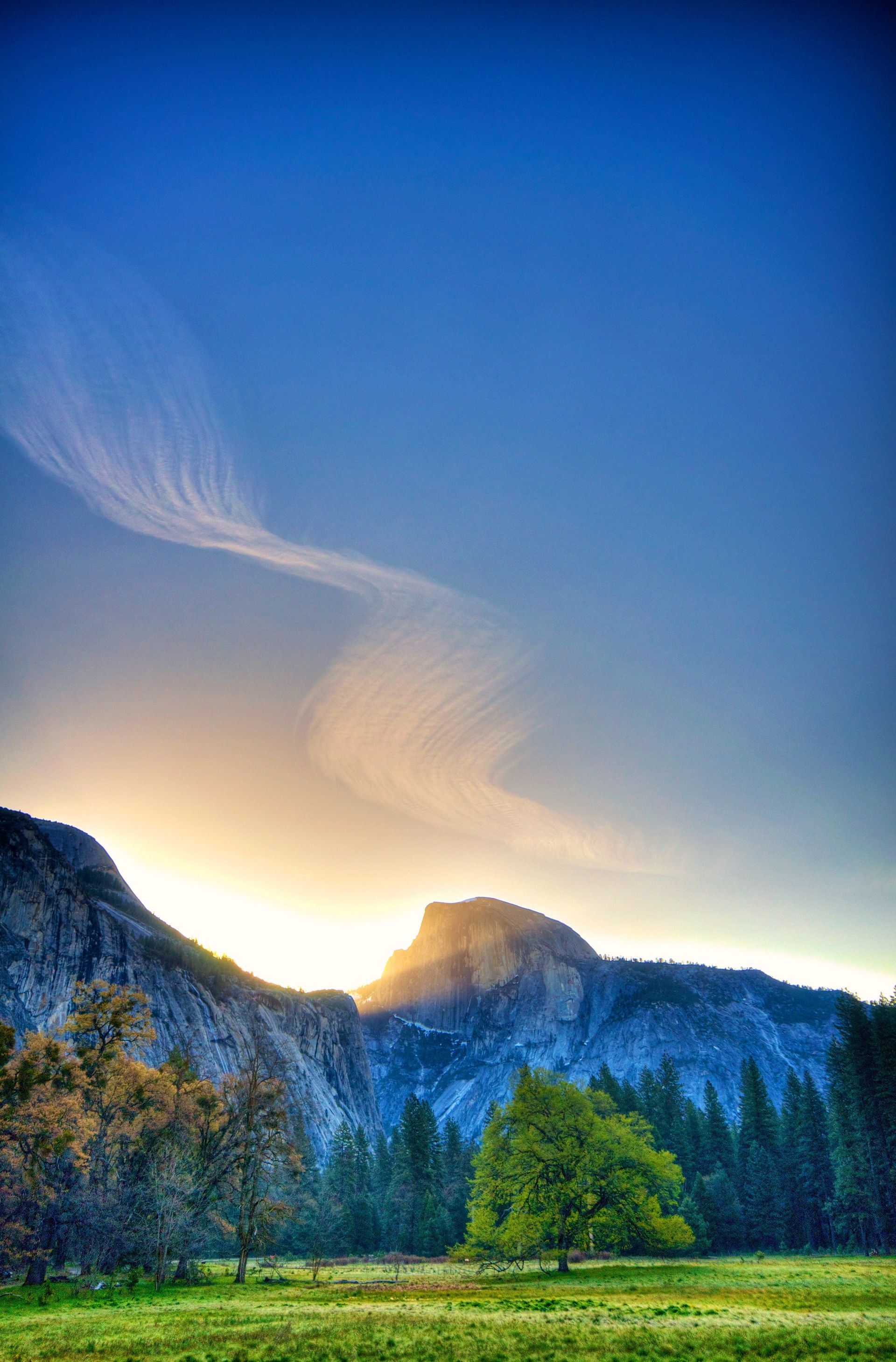 The sun rising over the Half Dome mountain in Yosemite National Park.