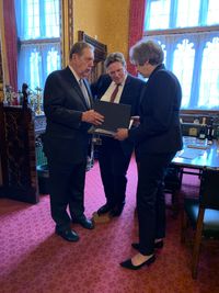 Elder Jeffrey R. Holland and Member of Parliament Stephen Kerr present British Prime Minister Theresa May with personal copies of her family history on November 21, 2018.