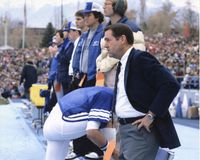 BYU President Jeffrey R. Holland watches a football game from the sidelines.