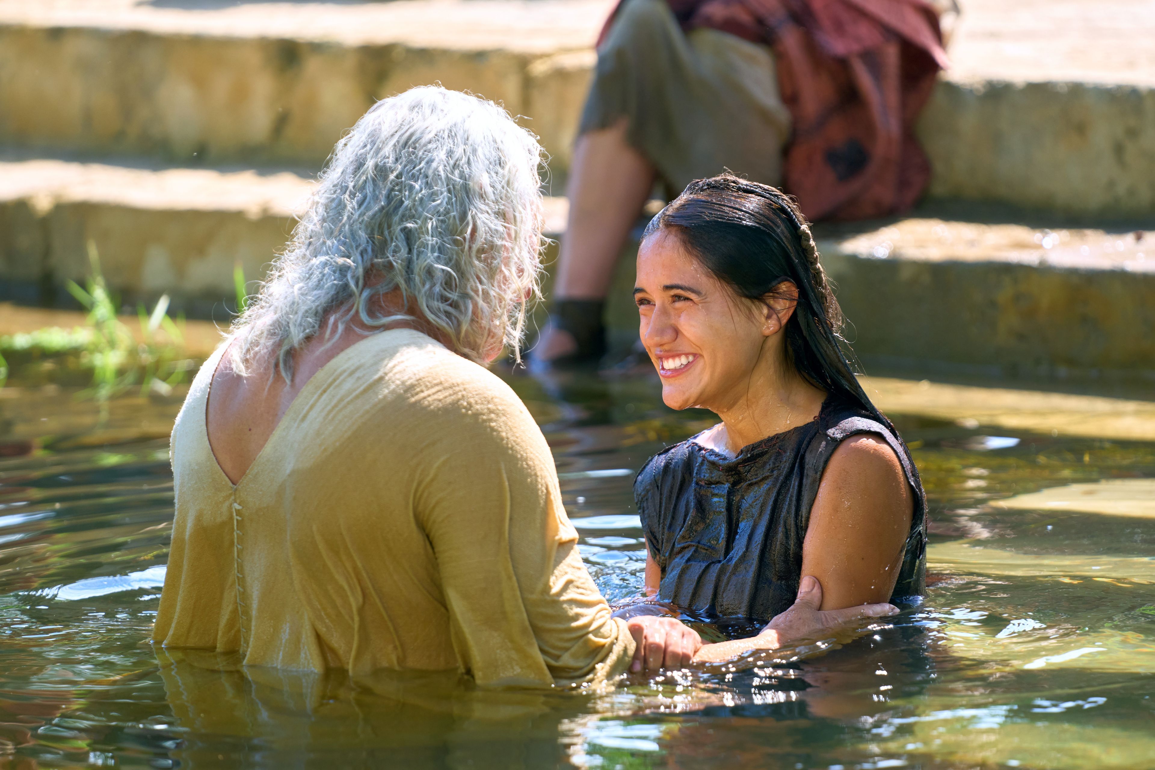 Nephi baptizes a woman while others watch. He had previously been set apart and given the authority by the resurrected Savior, Jesus Christ.