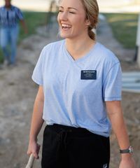 A sister missionary companionship walk together outside. They are modeling appropriate dress and grooming, as they are in jeans and t-shirts. They are dressed appropriately for giving service or being on their p-days.