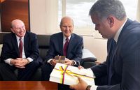 President Russell M. Nelson of The Church of Jesus Christ of Latter-day Saints, center, and Elder Quentin L. Cook of the Quorum of the Twelve Apostles, left, present gifts as they meet with Colombia president Iván Duque Márquez, right, in Bogotá, Colombia, Monday, August 26, 2019.