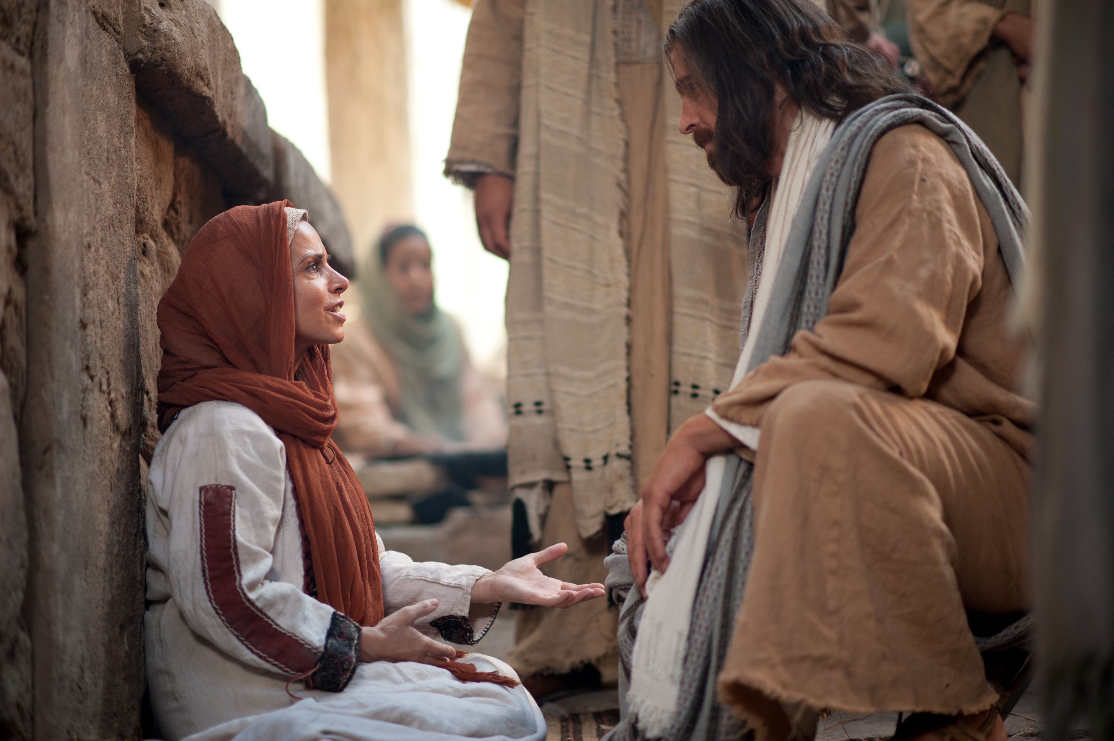 Christ conversing on the street with a woman of great faith who suffers from an issue of blood.