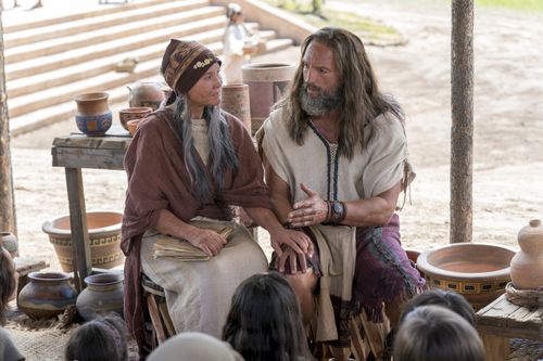 Nephi sits next to his wife as he teaches the people about baptism and the doctrine of Christ.