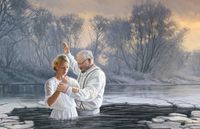 man baptizing woman
