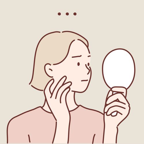 a short-haired woman holding a mirror and looking uncertain