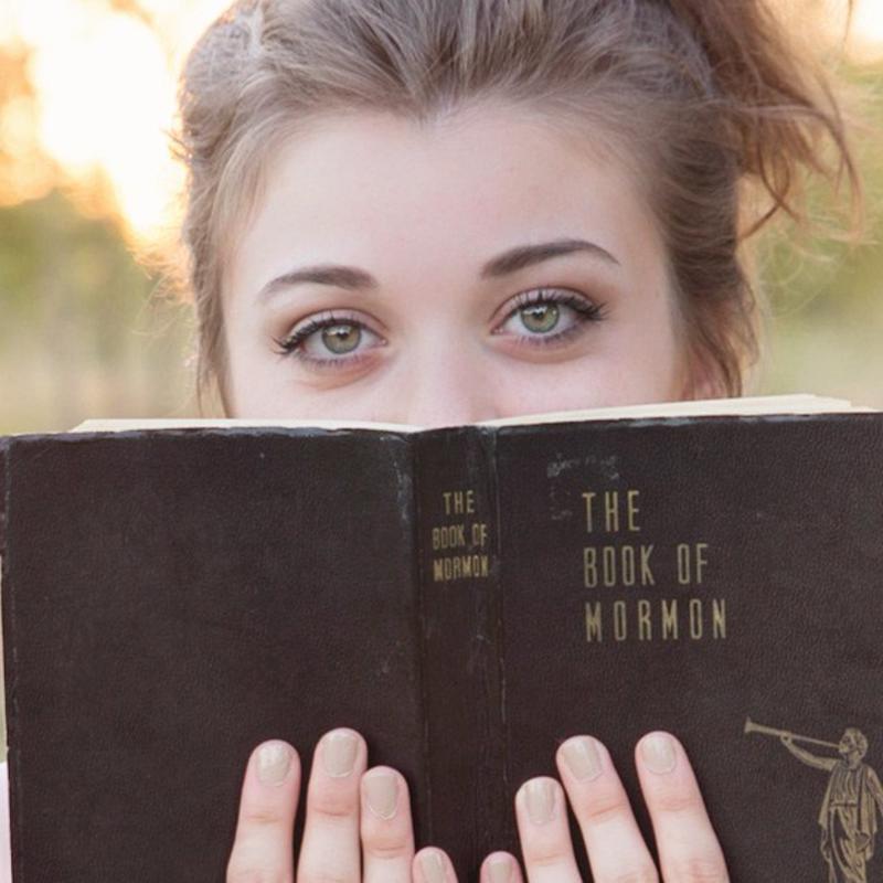 young woman holding scriptures